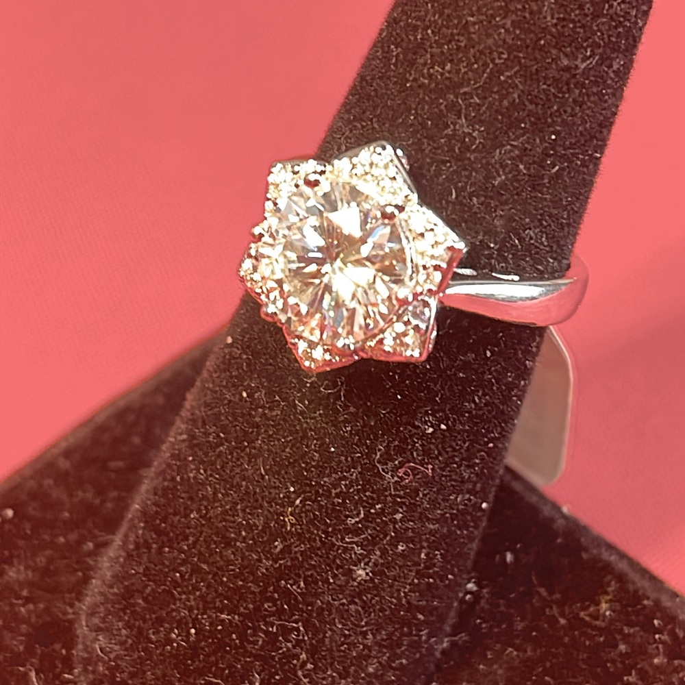 Moissanite 3.05 ctw.  Platinum over Sterling. Center stone approximately 3 ct